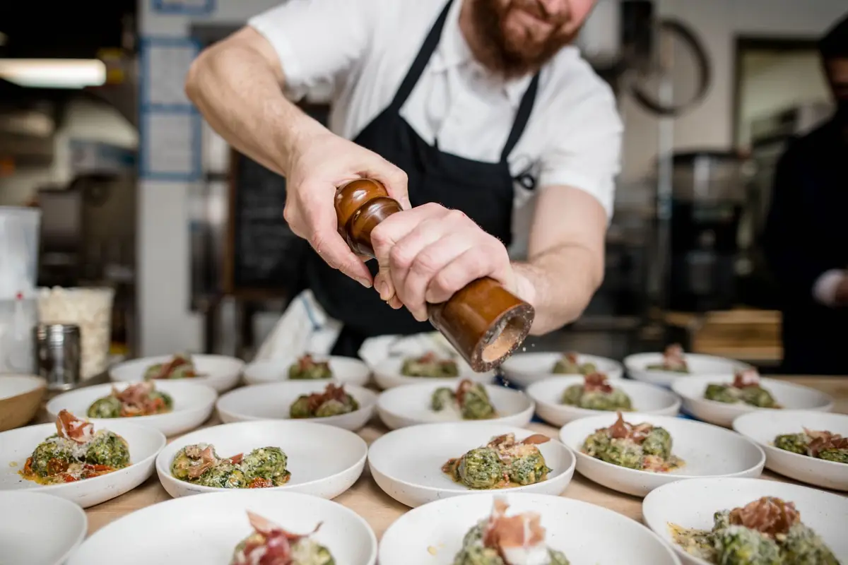 A chef preparing dishes in a kitchen